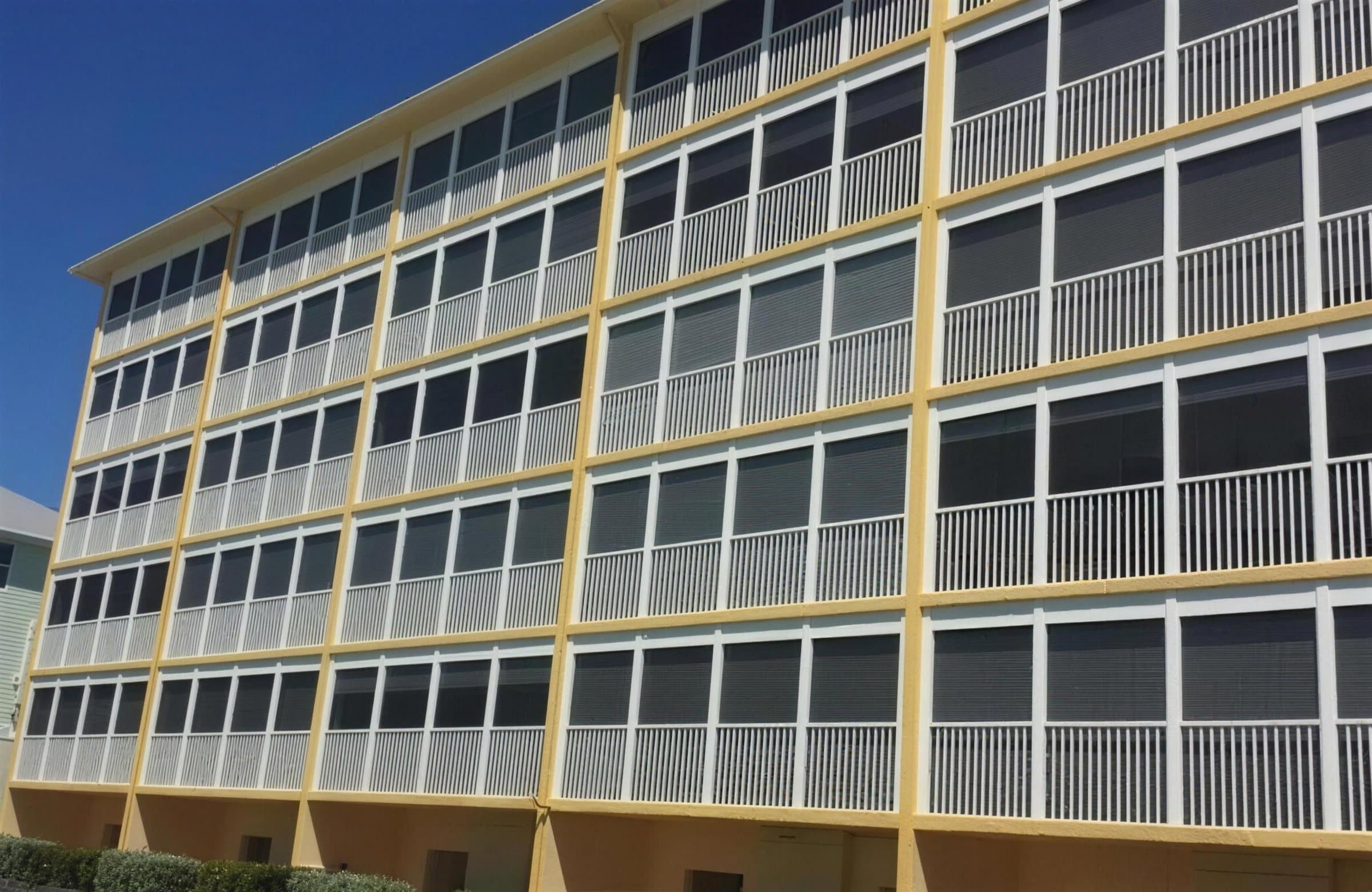 Five-story condominium building with shutters across every lanai